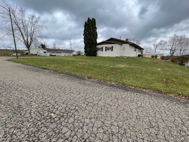 view of home's exterior with a yard