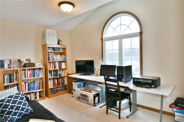 carpeted office featuring lofted ceiling