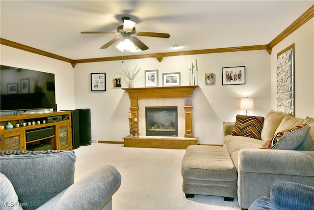 living room with carpet, ceiling fan, ornamental molding, and a fireplace