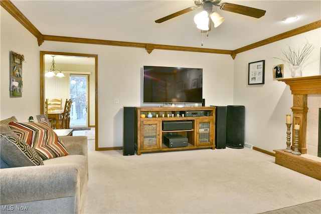 living room with ceiling fan with notable chandelier, light colored carpet, and ornamental molding