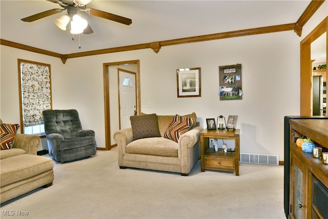 living room featuring ceiling fan, light colored carpet, and ornamental molding