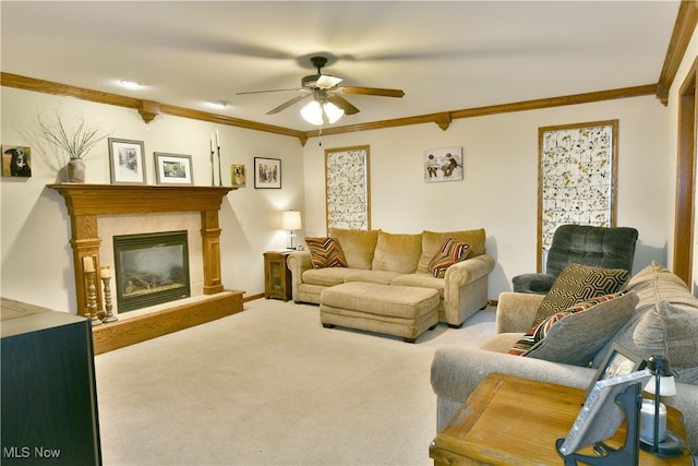 living room with ceiling fan, ornamental molding, and light carpet