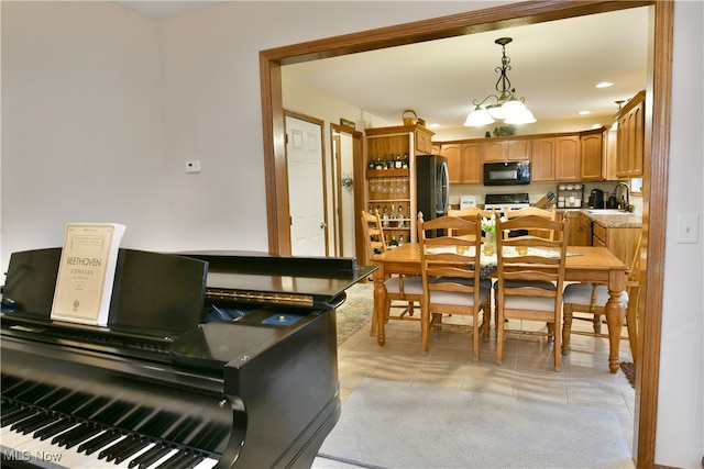 tiled dining area featuring an inviting chandelier and sink