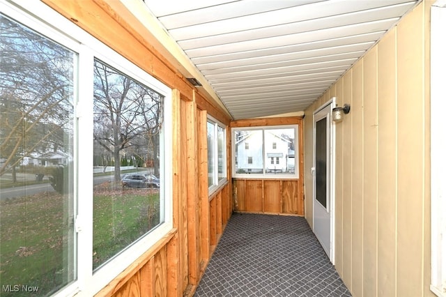 unfurnished sunroom featuring lofted ceiling