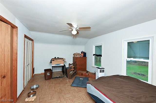 bedroom with light parquet floors, ceiling fan, and lofted ceiling