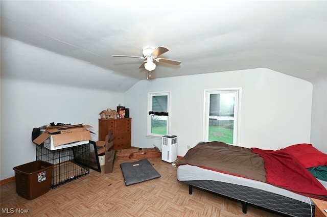 bedroom featuring light parquet floors, ceiling fan, and lofted ceiling