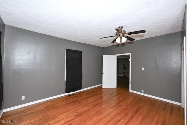 spare room featuring ceiling fan, a textured ceiling, and hardwood / wood-style flooring