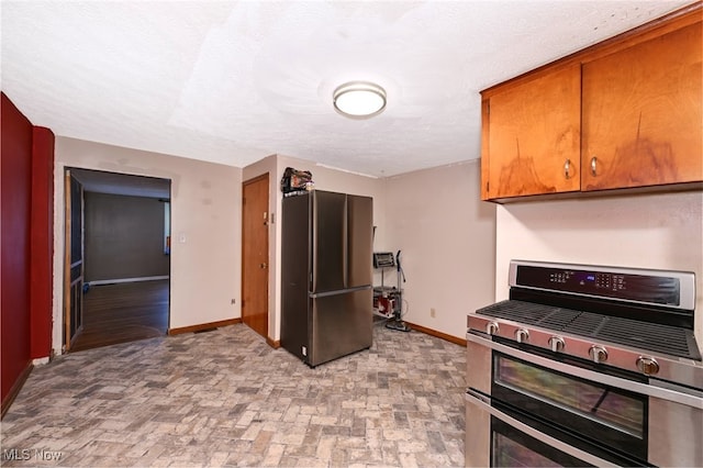 kitchen with a textured ceiling and stainless steel appliances