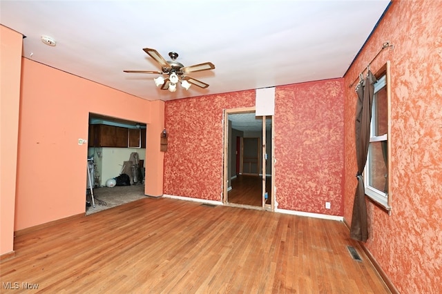 spare room featuring ceiling fan and hardwood / wood-style flooring