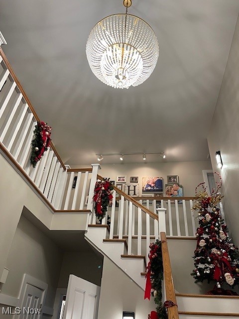 stairs featuring an inviting chandelier