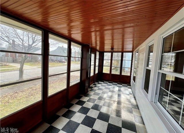 unfurnished sunroom featuring wooden ceiling