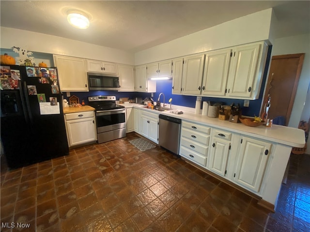 kitchen with kitchen peninsula, sink, white cabinetry, and stainless steel appliances