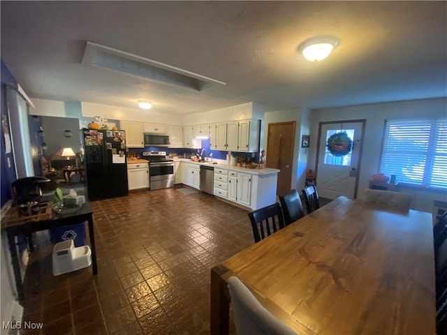 kitchen with white cabinetry, sink, and appliances with stainless steel finishes