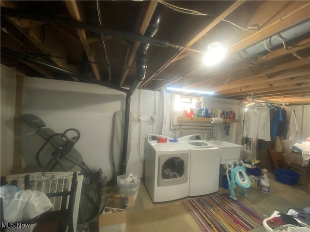 clothes washing area featuring sink and washer and dryer