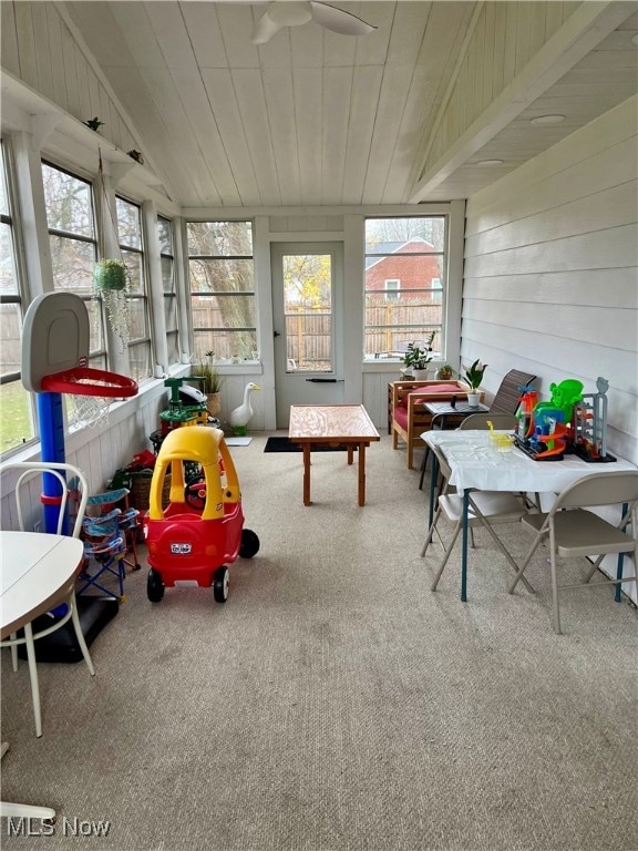 sunroom featuring lofted ceiling and wood ceiling