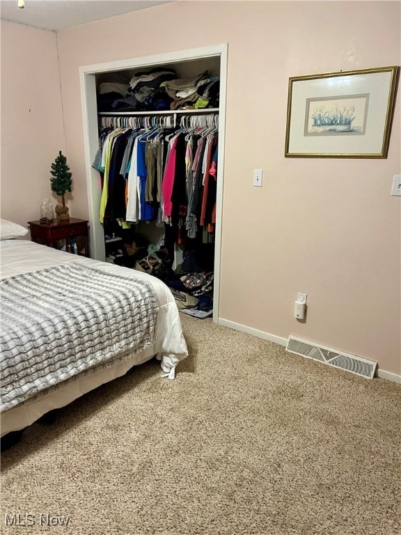 bedroom featuring carpet and a closet