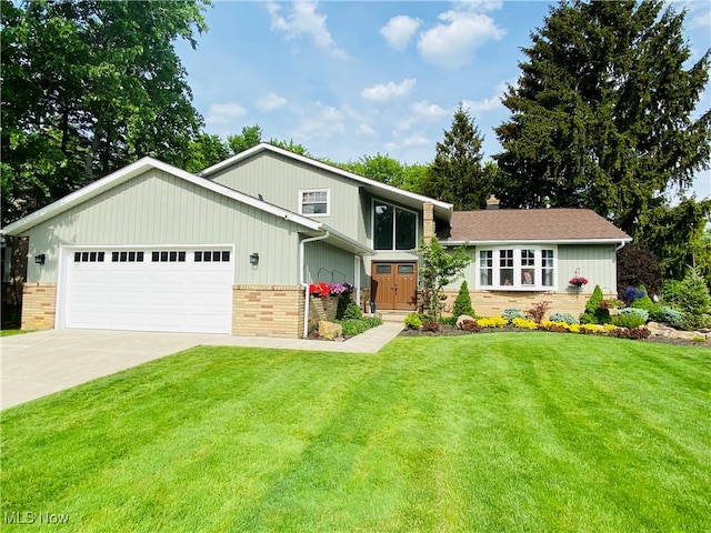 view of front of house with a garage and a front lawn