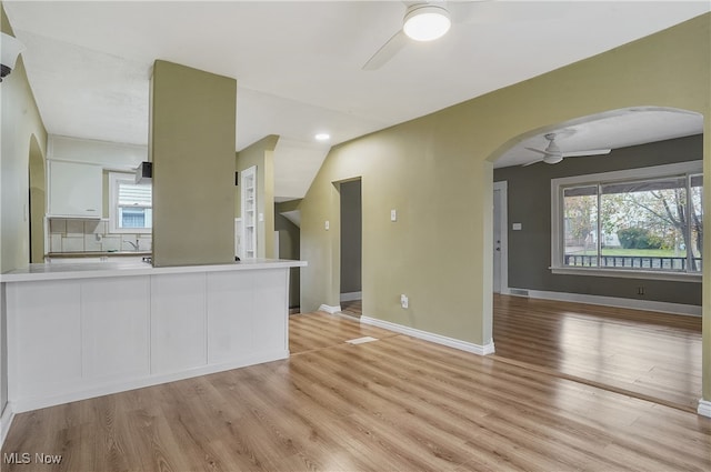 unfurnished living room featuring light wood-type flooring and ceiling fan