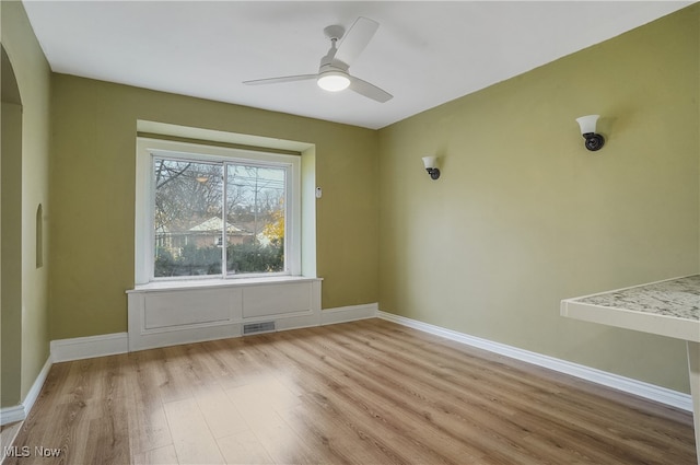 spare room featuring ceiling fan and light hardwood / wood-style floors