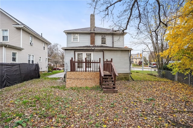 back of house featuring a wooden deck