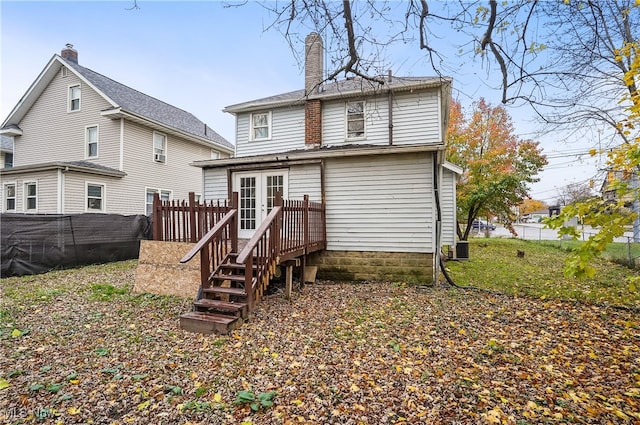 rear view of property featuring a deck