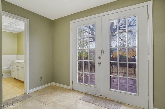 doorway featuring light tile patterned floors and french doors