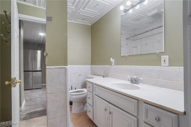 bathroom with vanity, coffered ceiling, tile patterned floors, toilet, and tile walls