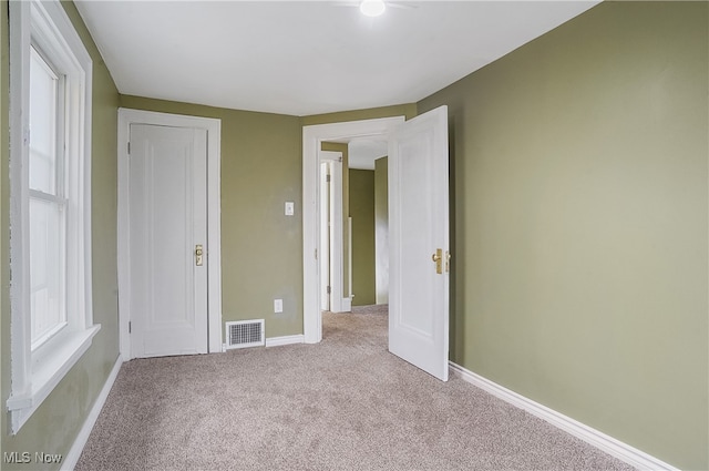 unfurnished bedroom featuring light colored carpet