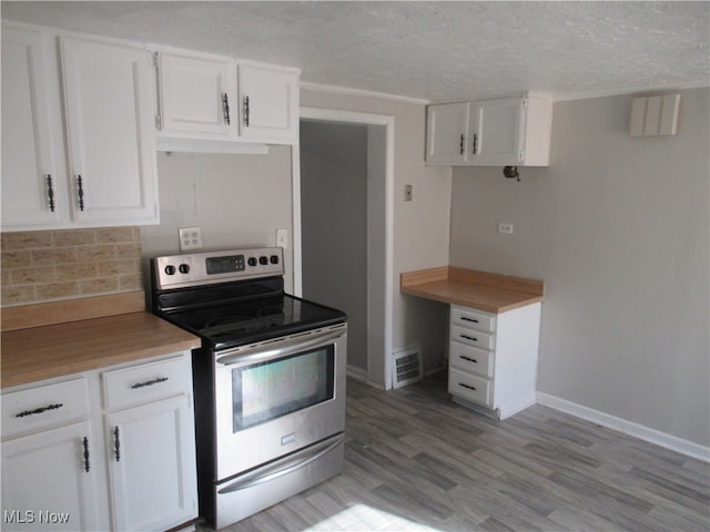 kitchen with decorative backsplash, a textured ceiling, electric stove, light hardwood / wood-style flooring, and white cabinets