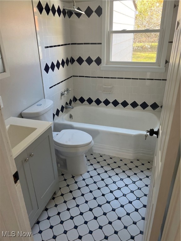 full bathroom with vanity, washtub / shower combination, and toilet