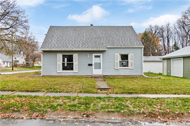 bungalow-style home with a front yard and a garage