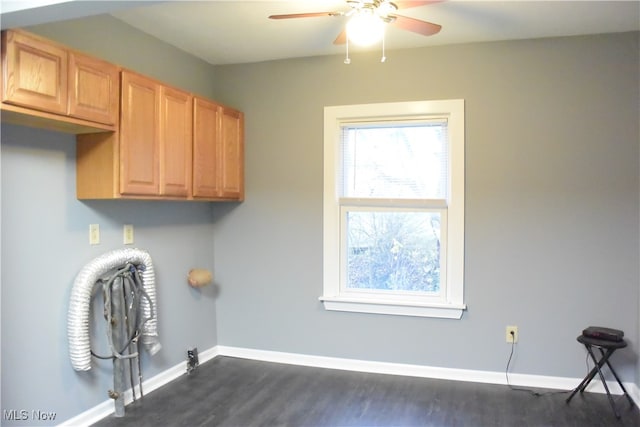 laundry area featuring cabinets, gas dryer hookup, ceiling fan, and dark wood-type flooring