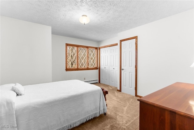 bedroom with light colored carpet, a textured ceiling, and a baseboard radiator