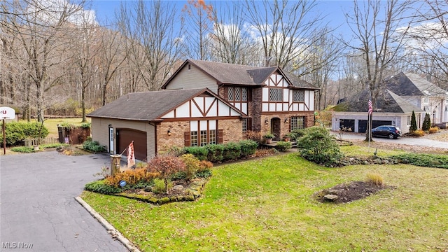 tudor-style house with a front yard and a garage