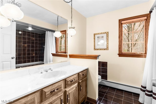 bathroom with tile patterned floors, walk in shower, vanity, a baseboard heating unit, and toilet