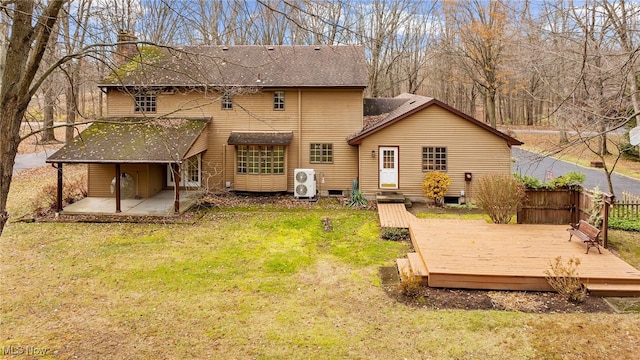 rear view of house with a lawn, a patio area, and a deck