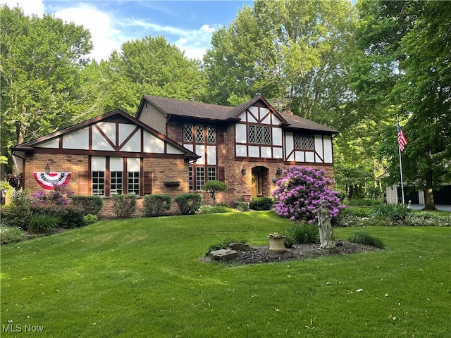 tudor-style house with a front lawn