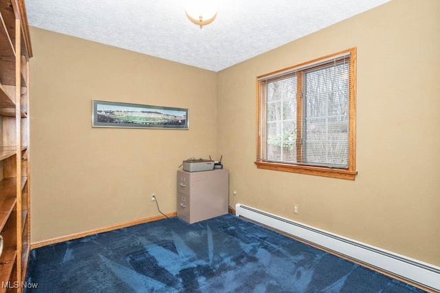 carpeted spare room with a textured ceiling and a baseboard radiator