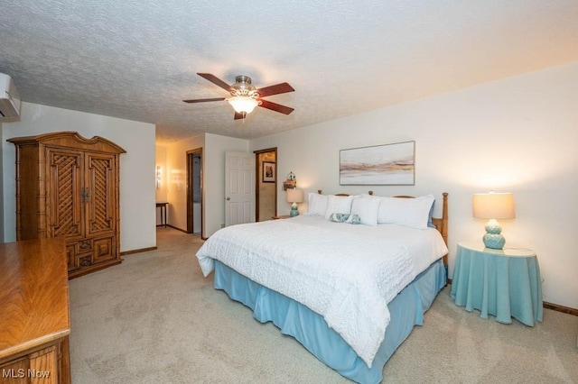 bedroom with ceiling fan, carpet floors, and a textured ceiling