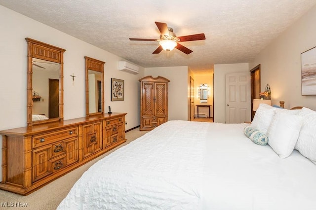 carpeted bedroom with a wall mounted air conditioner, a textured ceiling, and ceiling fan