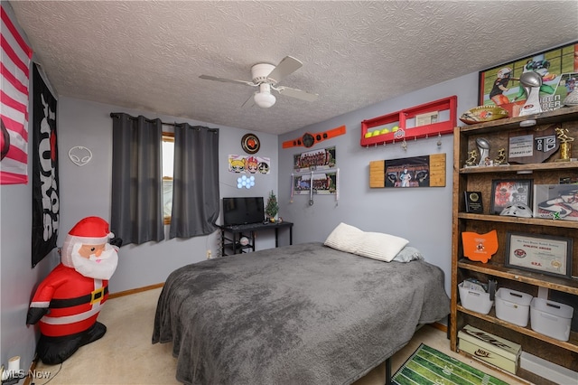 bedroom with ceiling fan, light carpet, and a textured ceiling