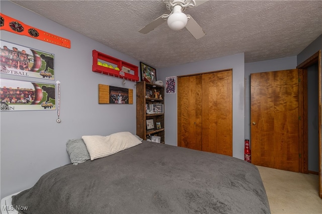 bedroom with carpet, a textured ceiling, a closet, and ceiling fan