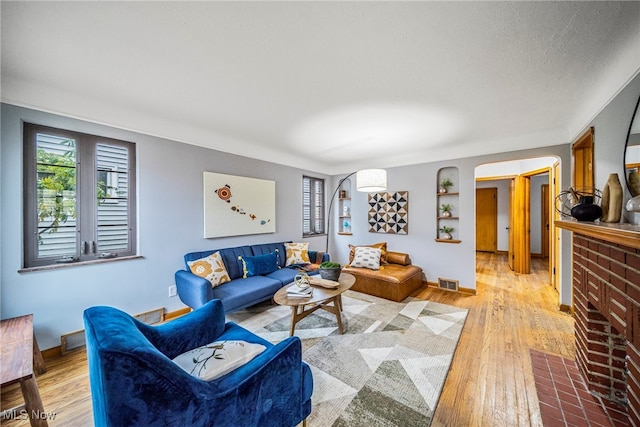 living room featuring a fireplace and light hardwood / wood-style flooring