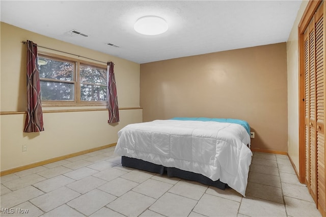 tiled bedroom with a closet