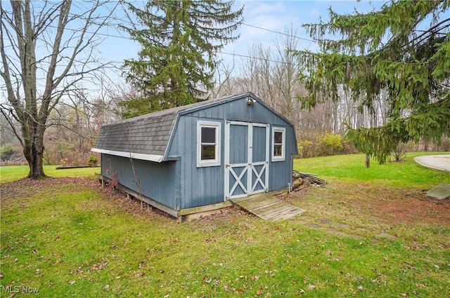 view of outdoor structure with a lawn