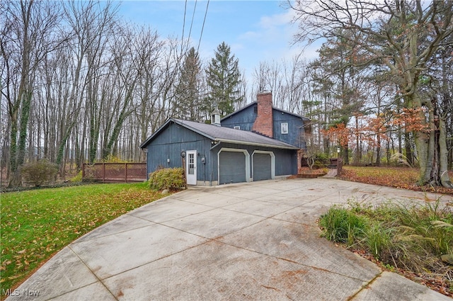 view of side of property featuring a yard and a garage