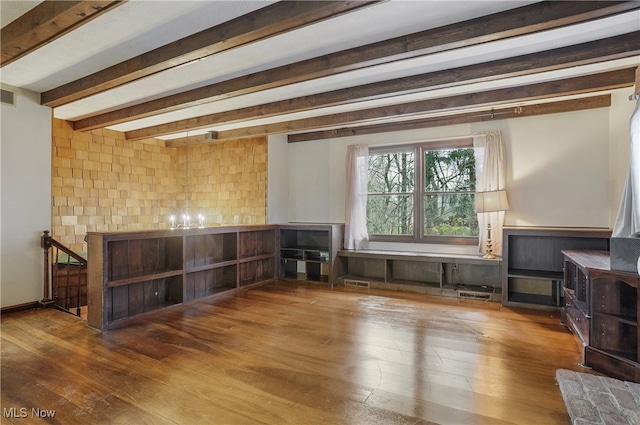 interior space with beamed ceiling and hardwood / wood-style flooring