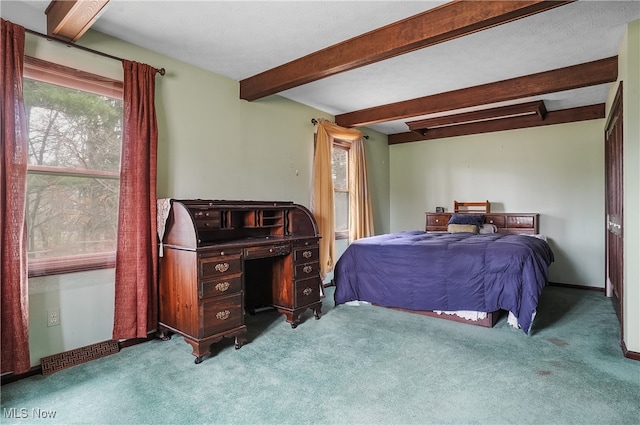 bedroom with beamed ceiling and light carpet