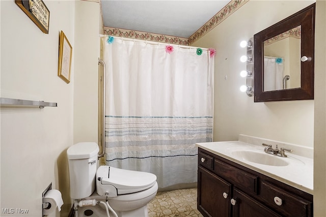 bathroom featuring tile patterned flooring, a shower with curtain, vanity, and toilet