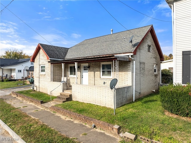 bungalow-style home featuring a front yard